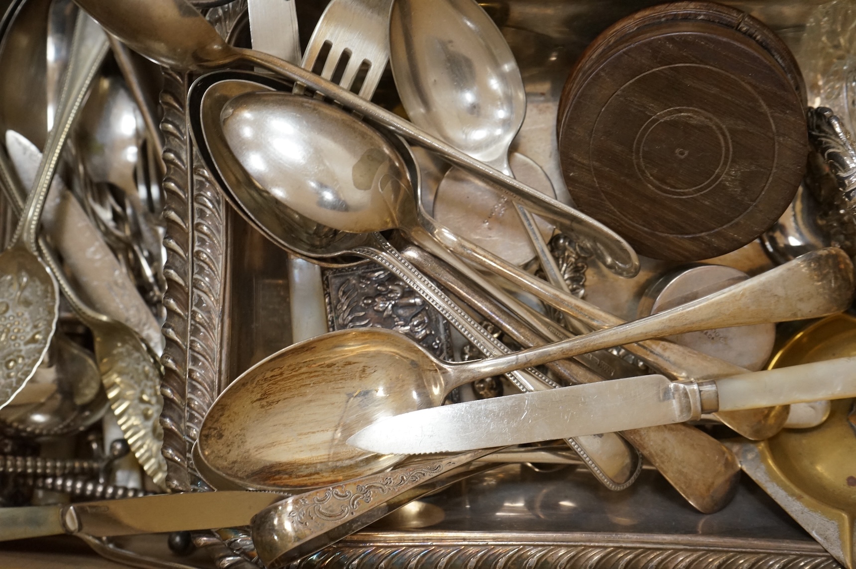 A group of assorted plated items including entree dishes, flatware and wine coaster.